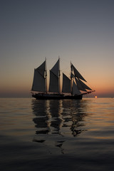 Fototapeta na wymiar Reflection of a sailboat