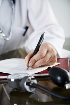 closeup  of doctor writing a prescription