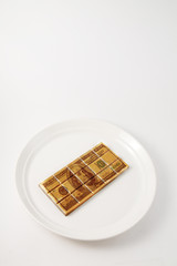 bar of chocolate with 100 dollars painted on it.