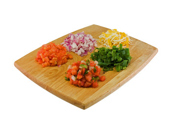 fresh, chopped ingredients on a cutting board on white