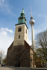 Berlin TV tower or Fernsehturm and St. Mary's Church in Alexanderplatz. The Fernsehturm is the...