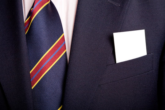 businessman with a blank business card in his pocket