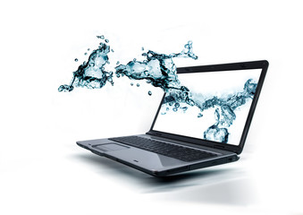 A notebook with water splashing out of the monitor.