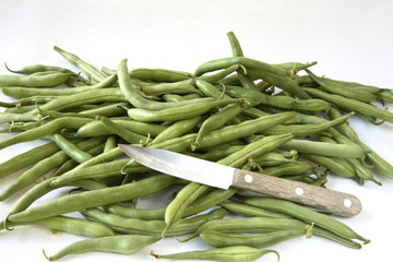 Pile of green bush beans with small vegetable knife