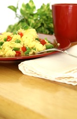 Fluffy scrambled eggs with red and green bell peppers