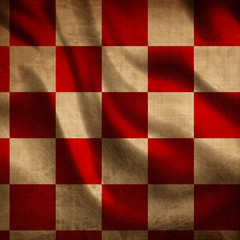 red picnic cloth with some folds in it