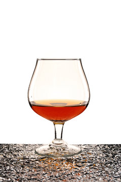 glass of brandy against white background