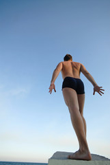 young  man on  background of  dark blue sky