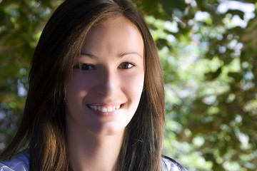 Close up on a Beautiful Teenager with Leaves in the Background