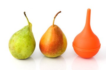 Two pears and a rubber siringe suggesting evolution process