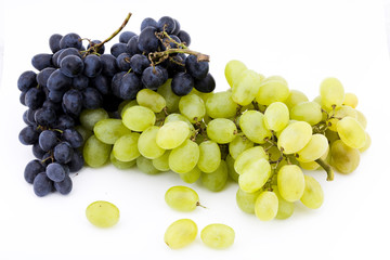 two bunches of red and white grapes on white background