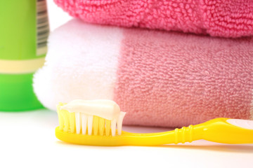 Yellow toothbrush with a toothpaste. Object over white