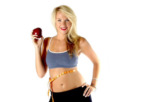 healthy blond in exercise outfit with a measuring tape