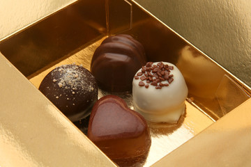 Sweet chocolate pralines in the golden box.