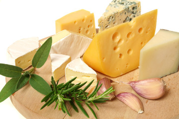 Cheese and herbs on a wooden board. Food photography.