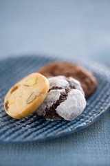 three homemade cookies on a blue ceramic plate
