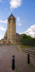 Fototapeta na wymiar medieval sandstone church with blue cloudy sky