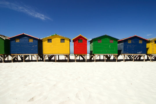 Multi colored beach huts in a row