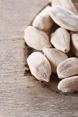 white cardamom pods on old wood, macro, shallow DOF