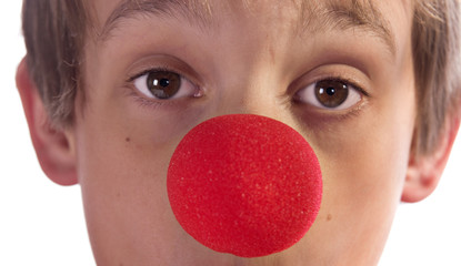 close up of a boys face with red nose