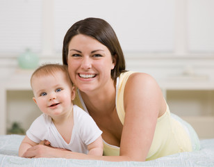 Close up of loving mother and baby posing at home