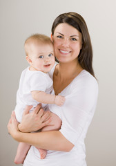 Studio shot of loving mother holding baby