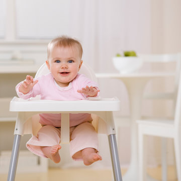 Hungry baby in highchair waiting to be fed