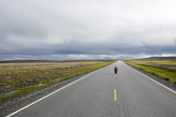 blonde little girl staying on highway