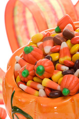 Orange pumpkin filled with delicious Halloween candies.