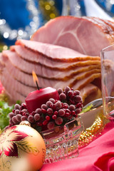 Holiday table setting with delicious whole baked sliced ham