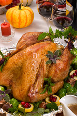 Garnished roasted turkey on holiday decorated table