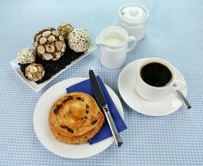 Delicious sultana danish pastry with a cup of black coffee