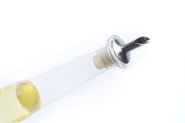 oil in a clear bottle on white background