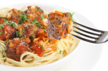 Italian meatballs with spaghetti. Selective focus on fork.