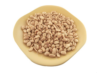 Close up of the salted peanuts on the yellow plate. Isolated.