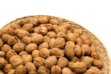 basket of harvest walnuts on white background