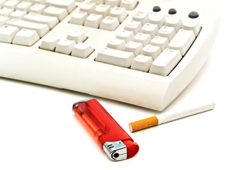 keyboard, cigarette and  lighter at the white table