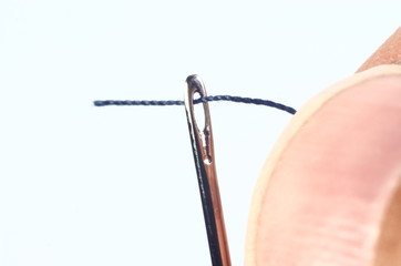 Needle with thread and nail