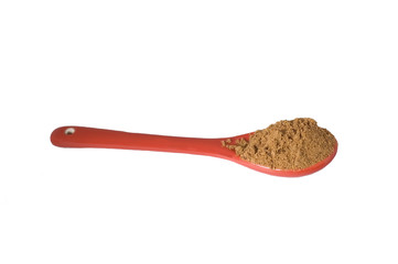 red spoon with black pepper
