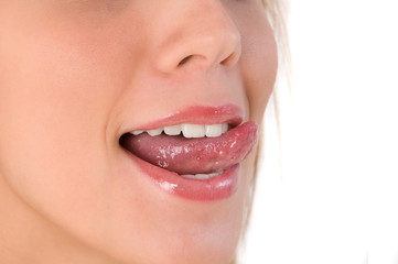 Beautiful woman leaking teeth with tongue close-up