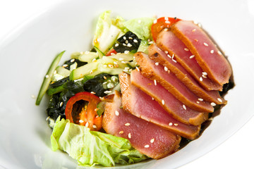 appetizer -  sausage with lettuce on the white plate