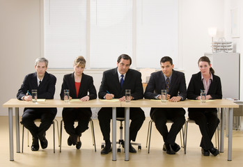 Panel of co-workers about to conduct a job interview - Powered by Adobe