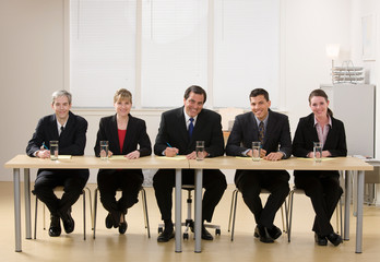 Panel of co-workers about to conduct a job interview