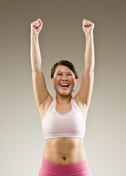 Woman in sportswear cheering and celebrating her success