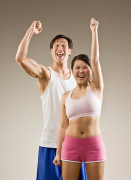 Man and woman cheering and celebrating their success