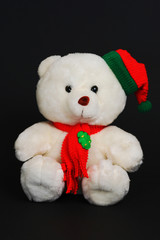christmas teddy bear isolated in black background.