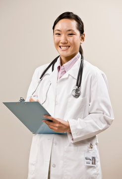 Confident Doctor Wearing Lab Coat And Stethoscope Holding Chart