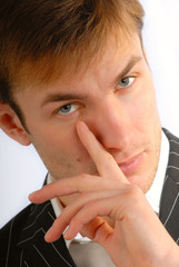 young businessman corrects near an eye on  person