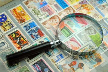 Stamps and Magnifying Glass.