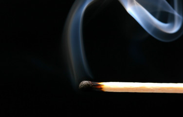 smoking match on black background as a hope concept